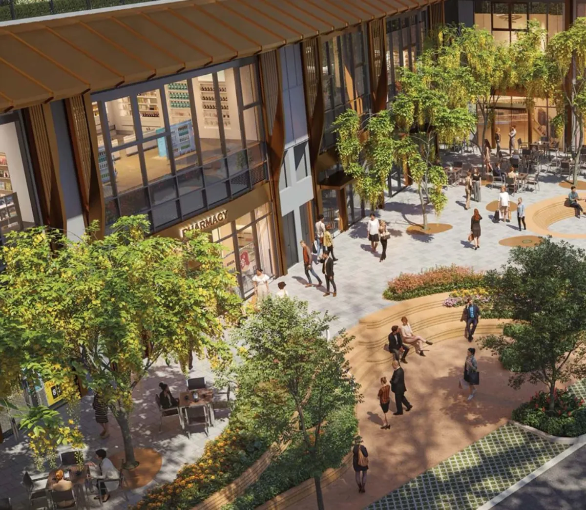The retail plaza at Eaton Park: shopfronts and cafés under the podium, with planting and seating across the paved square.